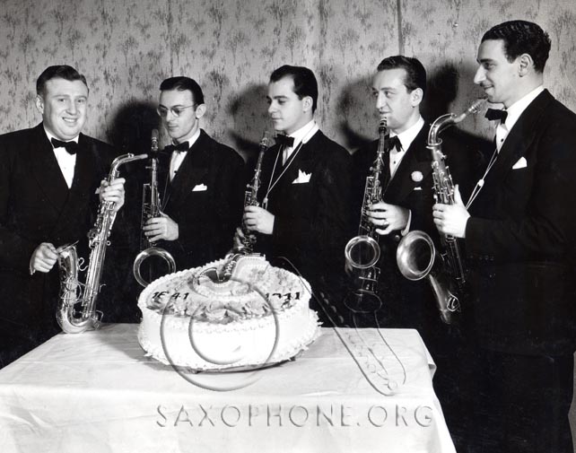 Richard Himber (left) posing with a recently patented Selmer-U. S. Padless saxophone and the saxophone section of his famous Studebaker Champions Orchestra